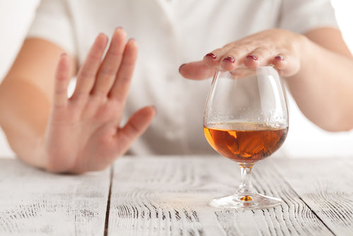  Woman saying no to alcohol and choosing tea instead for Dry January at Tea and Turmeric Laguna Beach California