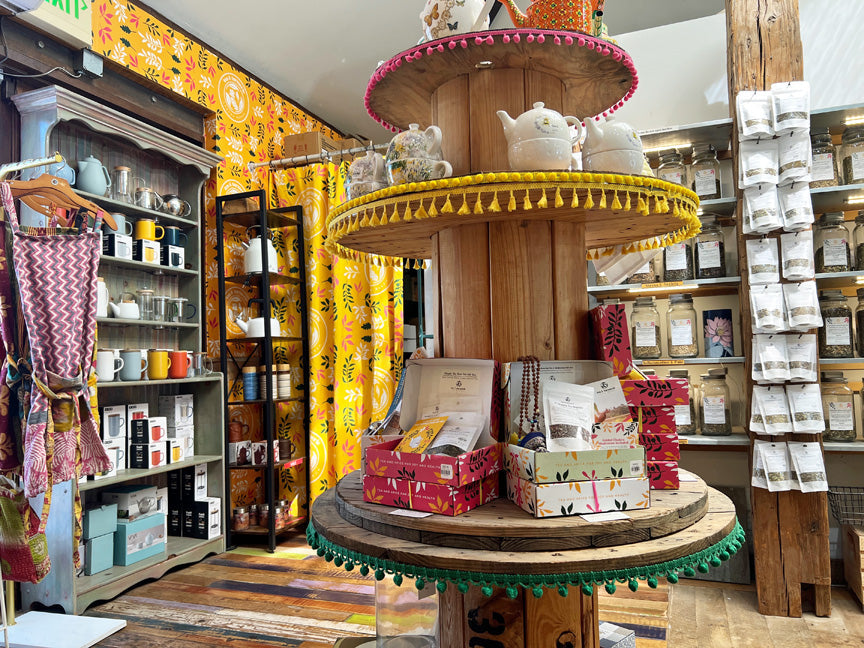 Interior of Tea & Turmeric loose-leaf tea store in Laguna Beach, Orange County, featuring tea jars, gift boxes, teapots, and colorful Indian-inspired decor