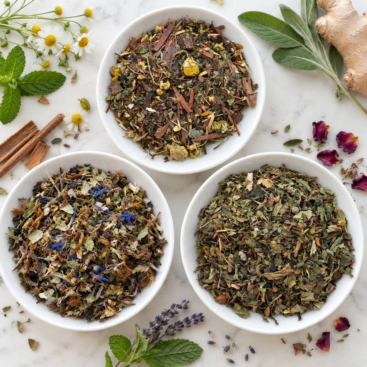 Three bowls of loose leaf tea blends with cornflower petals and chamomile for hormonal balance